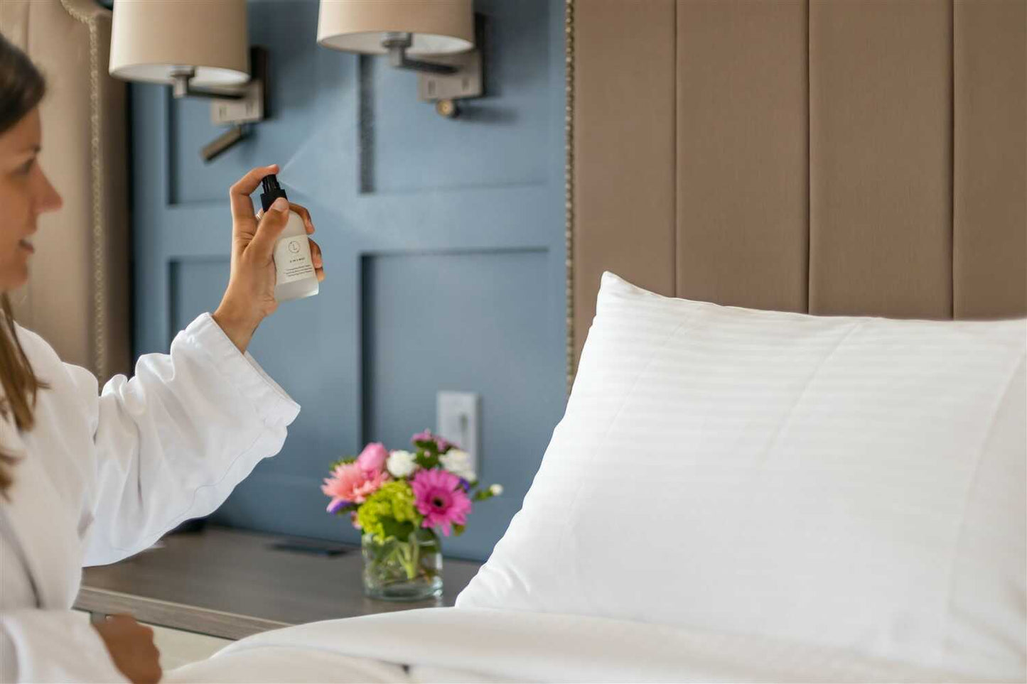 Person using Eucalyptus Mist spray on bed